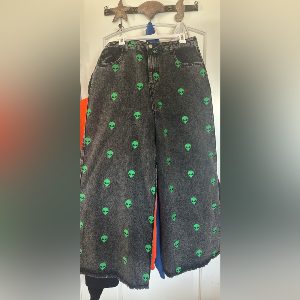 Dressed in LALA Black Flare Jeans with Green Alien Print - Picture 1 of 4